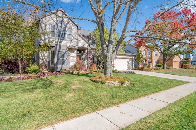 view of front of house featuring driveway, a garage, and a front yard