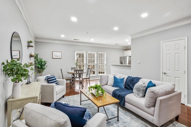 living room with baseboards, ornamental molding, wood finished floors, and recessed lighting