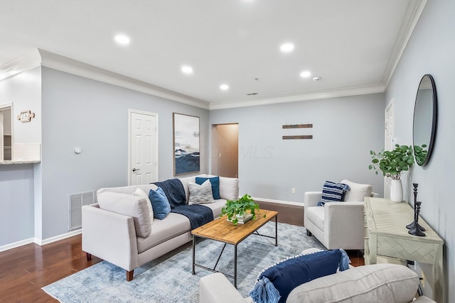 living area with baseboards, visible vents, wood finished floors, and ornamental molding