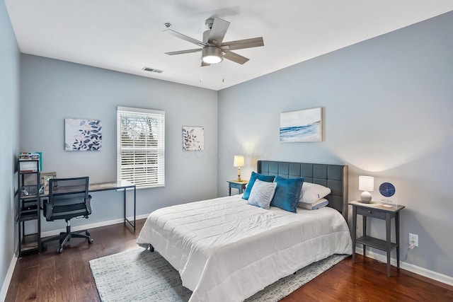 bedroom featuring a ceiling fan, wood finished floors, visible vents, and baseboards