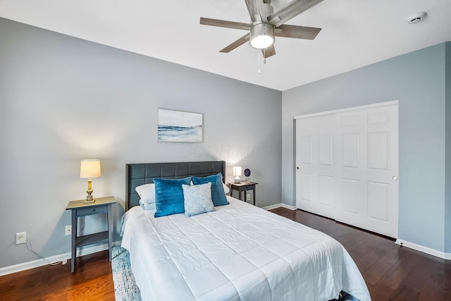 bedroom with a ceiling fan, a closet, baseboards, and wood finished floors