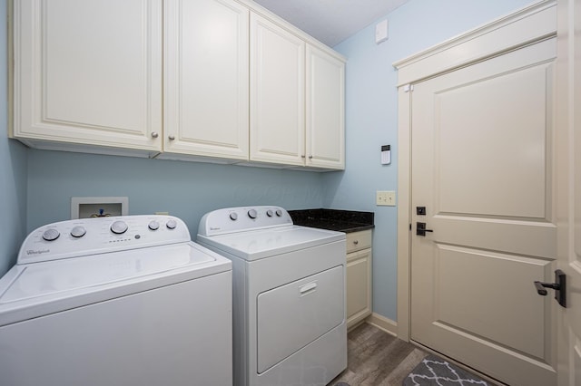 laundry area featuring cabinet space, dark wood-type flooring, and washer and dryer