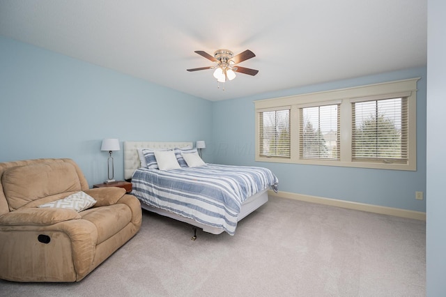 carpeted bedroom featuring a ceiling fan and baseboards