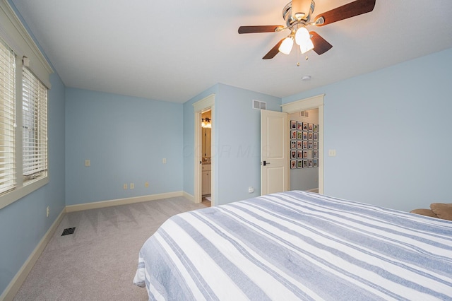 bedroom with baseboards, visible vents, a ceiling fan, and light colored carpet