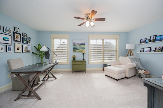 carpeted office with visible vents, ceiling fan, and baseboards