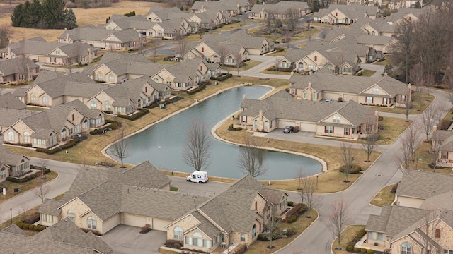 birds eye view of property with a residential view and a water view