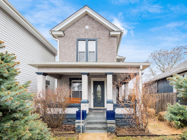 view of front facade featuring covered porch and stucco siding