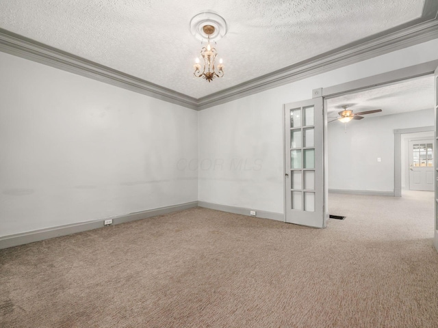 empty room featuring carpet floors, crown molding, a textured ceiling, baseboards, and ceiling fan with notable chandelier