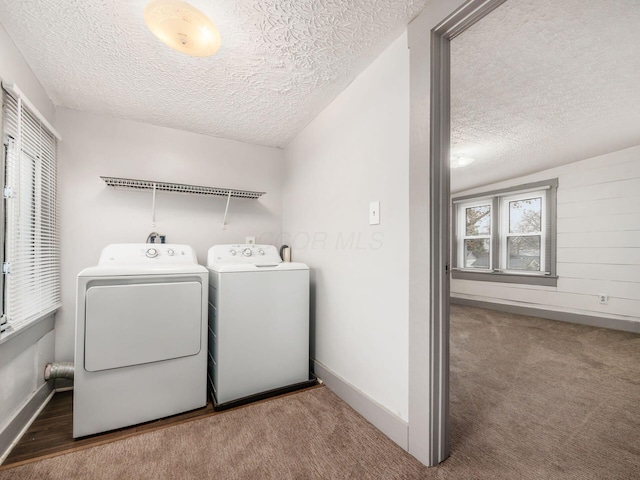 washroom with carpet floors, laundry area, a textured ceiling, and washing machine and clothes dryer