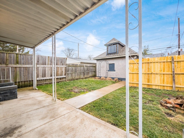 view of yard with a patio area, a fenced backyard, and an outdoor structure