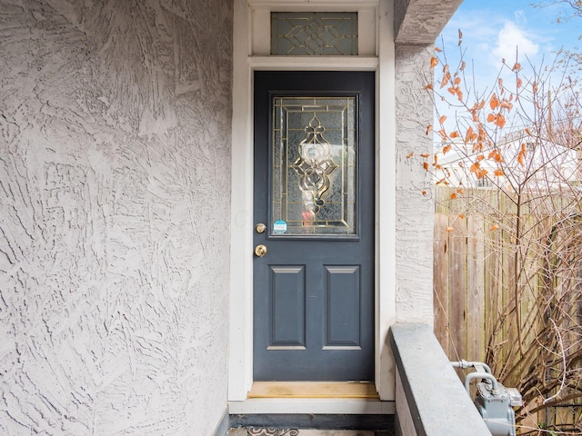 view of exterior entry featuring stucco siding