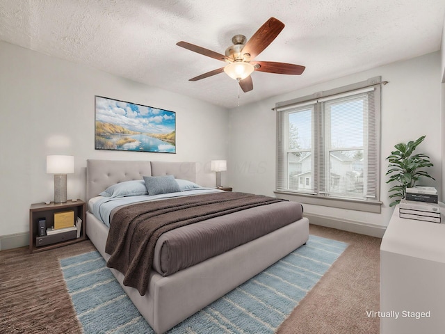 bedroom with a textured ceiling, ceiling fan, carpet, and baseboards