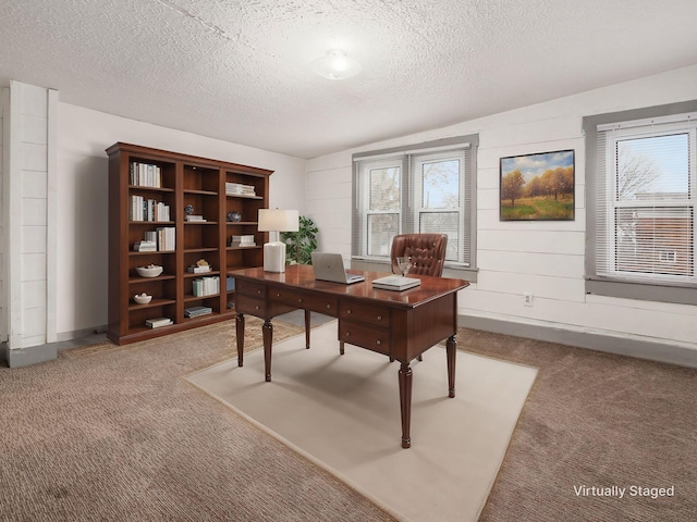 office space with carpet flooring, a textured ceiling, and baseboards