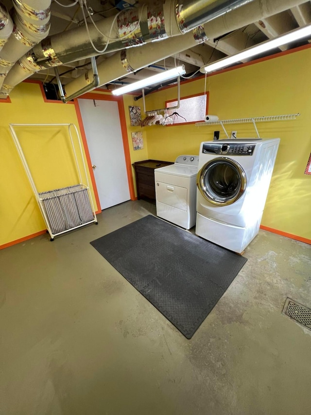 clothes washing area with laundry area, independent washer and dryer, and visible vents