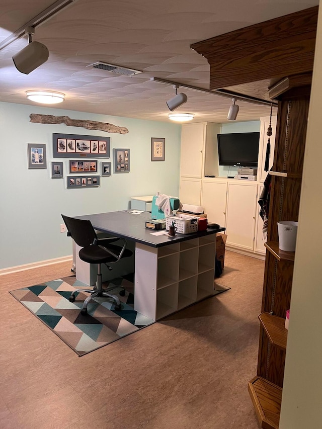 office with rail lighting and baseboards