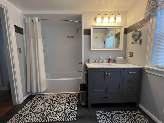 bathroom featuring visible vents, baseboards, vanity, and shower / bath combination with curtain