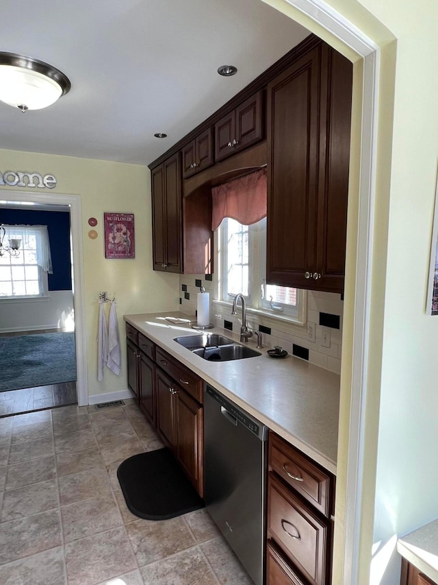 kitchen with a sink, light countertops, dark brown cabinets, stainless steel dishwasher, and backsplash