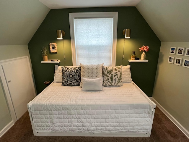 carpeted bedroom featuring baseboards and vaulted ceiling