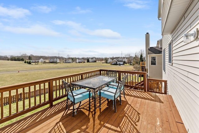 wooden terrace with a residential view and outdoor dining area