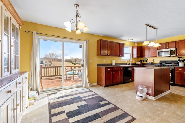 kitchen featuring range with gas stovetop, dark countertops, stainless steel microwave, and dishwasher