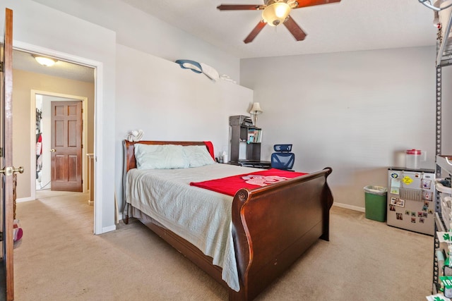 carpeted bedroom featuring ceiling fan and baseboards