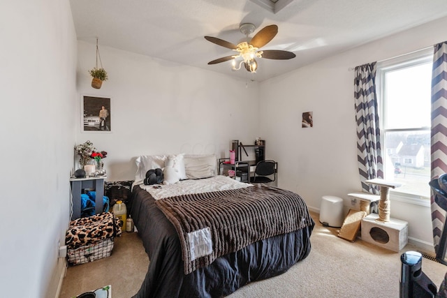 carpeted bedroom featuring a ceiling fan and baseboards