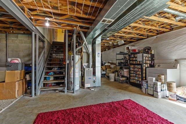 unfinished basement featuring washer / clothes dryer, stairway, gas water heater, and heating unit