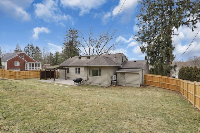 back of property with crawl space, a patio area, a fenced backyard, and a yard