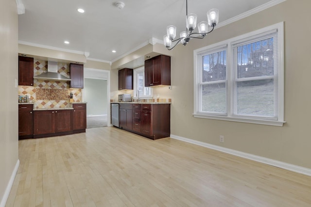 kitchen with ornamental molding, wall chimney exhaust hood, tasteful backsplash, and light wood-style flooring