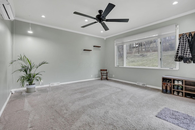 carpeted empty room featuring a wall unit AC, baseboards, visible vents, and ornamental molding