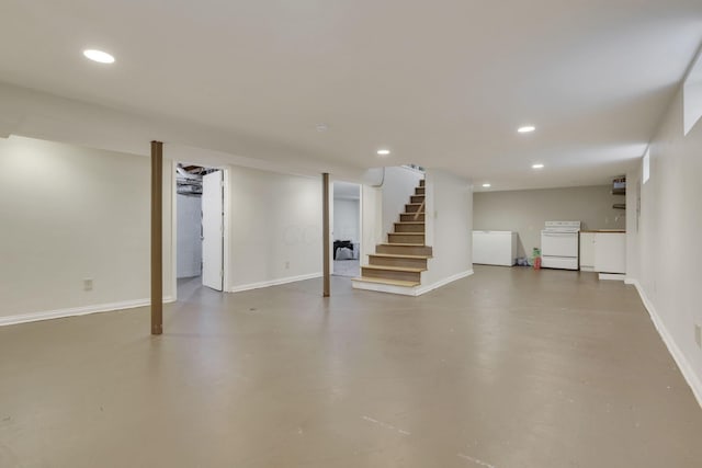 finished below grade area with stairway, baseboards, and recessed lighting