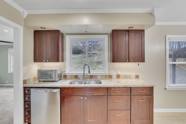 kitchen with dishwasher, light stone counters, a sink, and ornamental molding