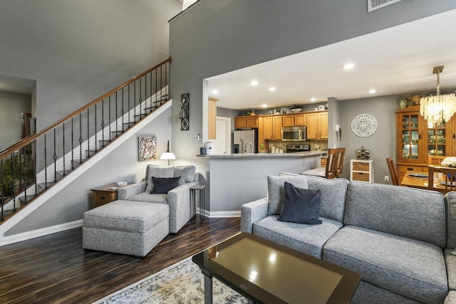 living area with stairs, dark wood-type flooring, baseboards, and recessed lighting