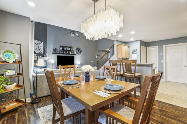 dining room featuring stairs, baseboards, wood finished floors, and recessed lighting