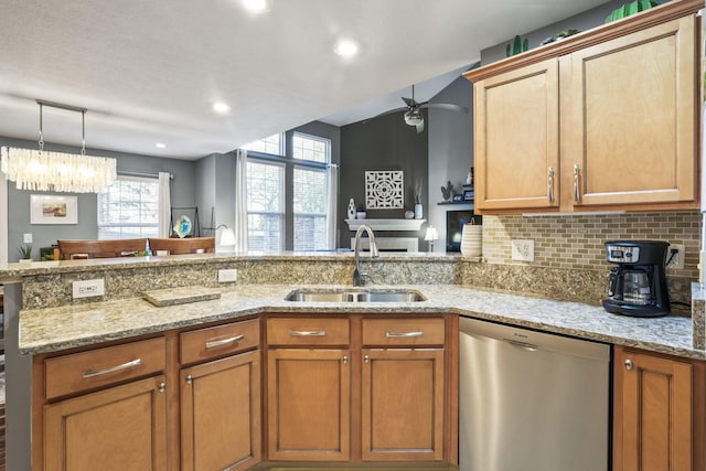 kitchen featuring decorative backsplash, dishwasher, a peninsula, light stone countertops, and a sink