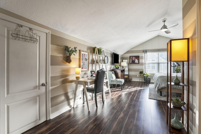 office area with lofted ceiling, a textured ceiling, wood finished floors, a ceiling fan, and baseboards