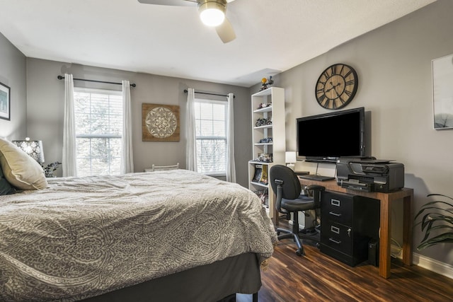 bedroom featuring dark wood-style flooring, ceiling fan, and baseboards