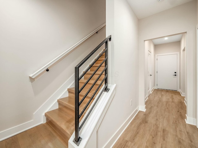 stairs featuring baseboards and wood finished floors