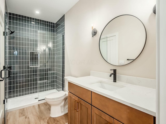 1093 Franklin Ave, Columbus, OH 43205 - bathroom with vanity, a stall shower, wood finished floors, and toilet