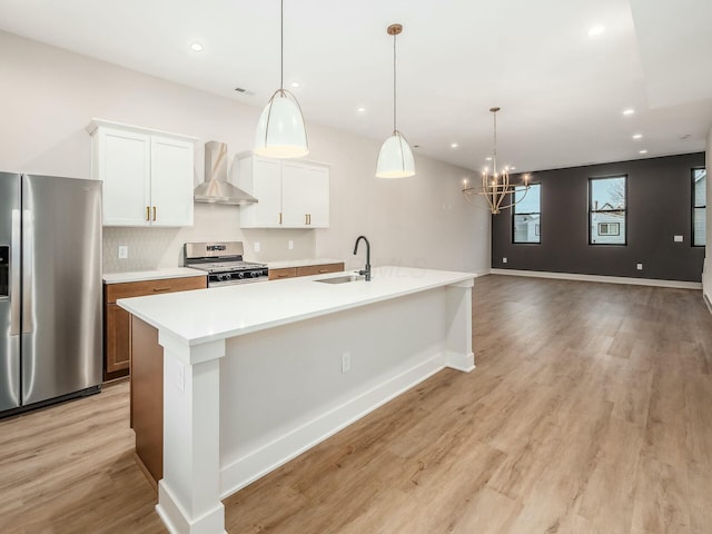 1093 Franklin Ave, Columbus, OH 43205 - kitchen featuring recessed lighting, appliances with stainless steel finishes, a sink, wall chimney range hood, and light wood-type flooring