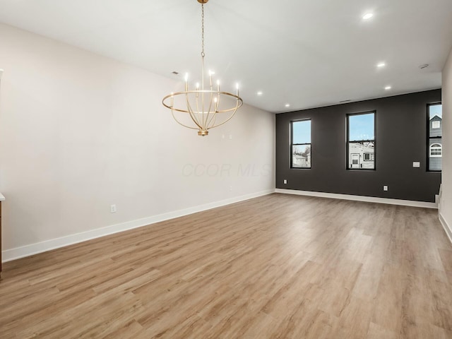 1093 Franklin Ave, Columbus, OH 43205 - spare room with light wood-style floors, recessed lighting, a notable chandelier, and baseboards