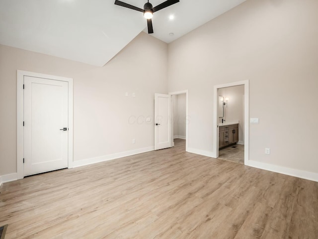 1093 Franklin Ave, Columbus, OH 43205 - unfurnished bedroom with light wood finished floors, visible vents, baseboards, ensuite bathroom, and high vaulted ceiling