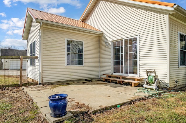 rear view of property featuring metal roof and a patio