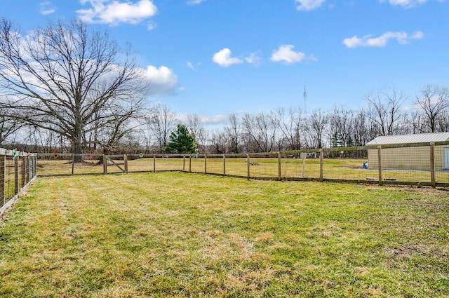 view of yard featuring a rural view and fence