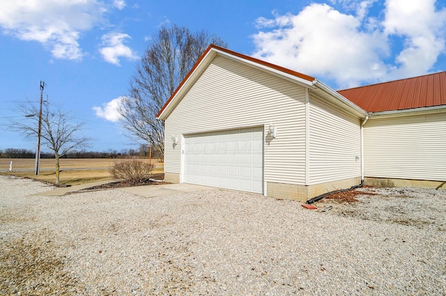 garage with gravel driveway