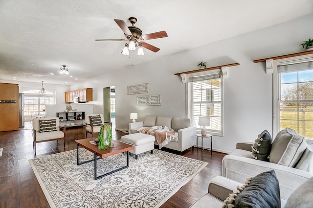 living room featuring ceiling fan, dark wood-type flooring, plenty of natural light, and baseboards