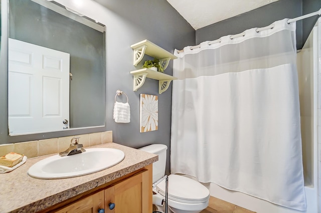 bathroom with toilet, tile patterned floors, shower / bathtub combination with curtain, and vanity