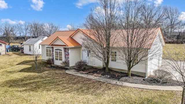 view of front of house with metal roof and a front lawn