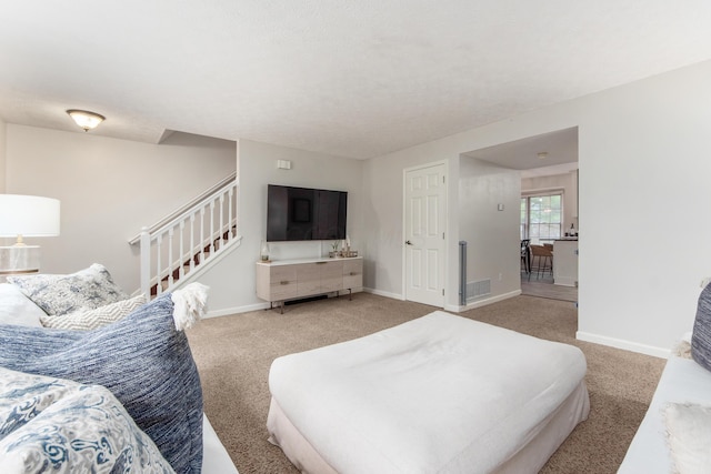 carpeted bedroom with visible vents and baseboards