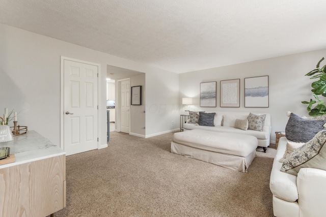 living room with light carpet, baseboards, and a textured ceiling